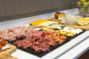 a bunch of different types of food on a table at Acta The Avenue in Porto