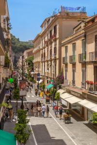 a group of people walking down a street with buildings at Palazzo Starace in Sorrento