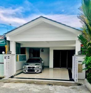 a car parked in front of a house at Pinggiran Homestay in Batu Caves