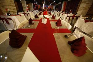 a long table with red napkins and white chairs at Yangthang Heritage in Gangtok