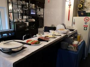 a kitchen counter with plates and food on it at Jole in Rumšiškės