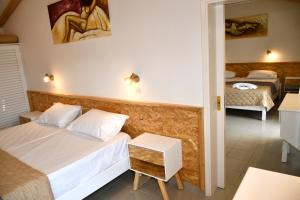 A bed or beds in a room at Cavos Beach House