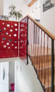 a staircase with a red railing with white polka dots at Apple tree in Zagreb