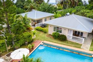 an aerial view of a house with a swimming pool at Felicie Cottage & Residence in Anse Royale