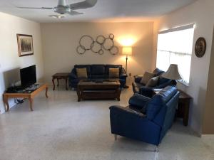 a living room with blue couches and a tv at Water FUN! poolPIERkayaksCANOE MotorBoatRENTALpets in Englewood