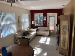 a living room with a couch and a table at Water FUN! poolPIERkayaksCANOE MotorBoatRENTALpets in Englewood