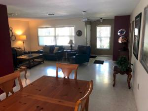 a living room with a wooden table and a couch at Water FUN! poolPIERkayaksCANOE MotorBoatRENTALpets in Englewood +41 photos