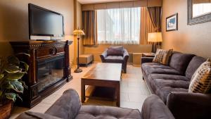a living room with a couch and a fireplace at Best Western Lower South End in Charlotte