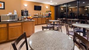 a restaurant with tables and chairs and a counter at Best Western Lower South End in Charlotte