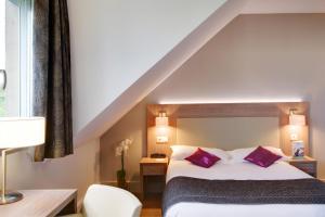Postelja oz. postelje v sobi nastanitve Best Western Plus Hotel Du Parc Chantilly