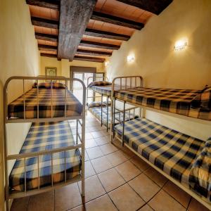 a row of bunk beds in a room at ALBERGUE SAN SATURNINO in Ventosa