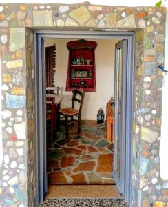 a door into a room with a stone floor at Christianna's Home in Stavrokhórion