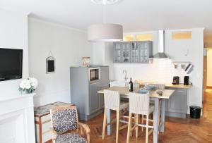 a kitchen with a table and chairs and a refrigerator at L'Appart D'Oli et Tiane in Bordeaux