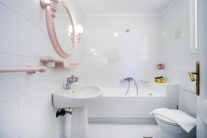 a white bathroom with a sink and a toilet at Metropolis House in Chania Town +15 photos