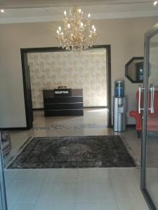 een woonkamer met een kroonluchter en een grote deur bij Erasmia Palms Boutique Hotel & Spa in Centurion
