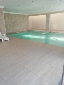 a large swimming pool in a large room with at Erasmia Palms Boutique Hotel & Spa in Centurion