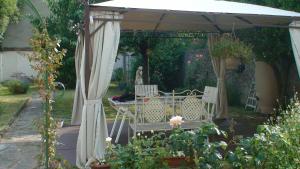 a gazebo with a table and chairs under it at Côté Marne in Champigny-sur-Marne