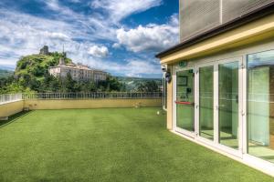 a balcony with a view of a castle at Hotel Il Duca Del Montefeltro in Pennabilli