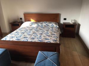 a bedroom with a bed and two night stands at B & B Lmc LA MADONNINA CHALET in Casteggio