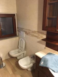 a small bathroom with a toilet and a sink at B & B Lmc LA MADONNINA CHALET in Casteggio