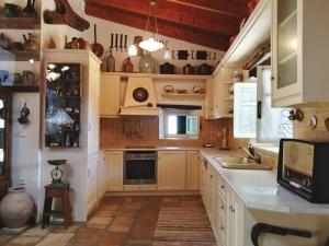 a kitchen with white cabinets and a counter with a sink at Casa Victoria in Katokhórion