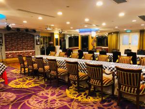 a large room with a long table and chairs at Hotel Riviera Macau in Macau