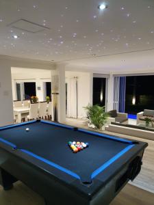 a large living room with a pool table at Strode House in Knysna