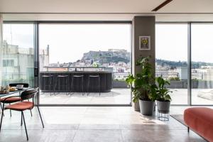 a living room with a view of the city at Perianth Hotel in Athens