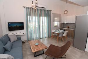a living room with a blue couch and a table at Melia Luxury Suite with pool in Iraklitsa