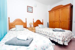 Posteľ alebo postele v izbe v ubytovaní Apartamentos Super