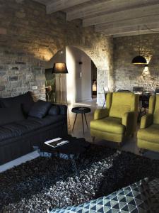 a living room with a couch and two chairs and a table at Casa Della Vita Gouves Cretan Luxury Villa in Gournes