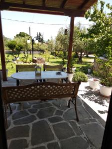 a table and a bench on a patio at Avra Ηouse in Kriopigi