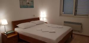 a bedroom with a bed with two towels on it at Truly Mediterranean Apartment "Spark" in Korčula