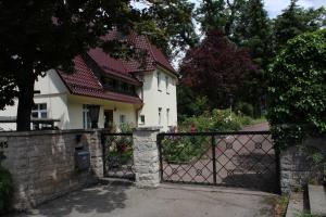 a white house with a gate in front of it at Ferienwohnung in herrlicher Lage in Bad Urach