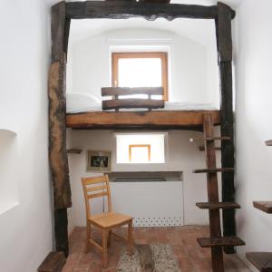 a room with a bunk bed and a chair at Hostel Celica in Ljubljana +62 photos