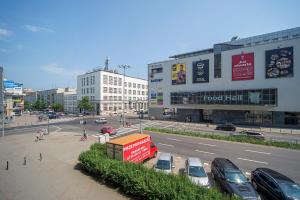 a city street with cars parked in a parking lot at 4 Apart in Gdynia