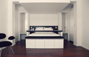 Cama ou camas em um quarto em Le Grand Hotel de la Plage