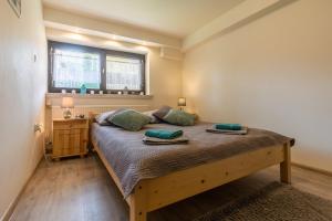 a bedroom with a large bed with two pillows on it at Apartament Ewa in Zakopane