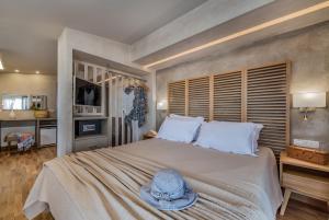 a bedroom with a bed with a hat on it at Phoenix Hotel in Zakynthos Town