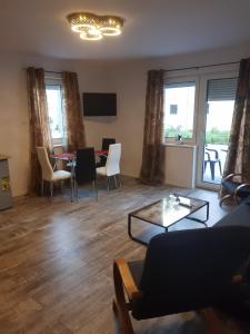 a living room with a couch and a table at Apartamenty u Tatiany in Międzywodzie
