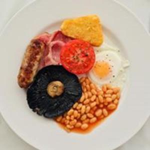 a plate of breakfast food with eggs beans and toast at The Snowdon House in Shanklin