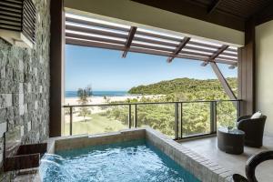 a swimming pool with a view of the ocean at Shangri-La Rasa Ria, Kota Kinabalu in Kota Kinabalu