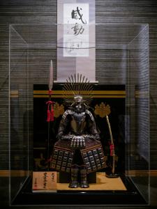 a statue of a samurai in a glass display case at SAMURAI HOUSE Ⅱ in Nagoya