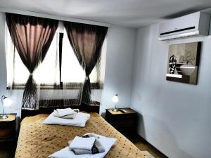 - une chambre avec 2 lits et une fenêtre dans l'établissement Pensiunea Roua Florilor, à Anina