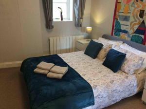 a bedroom with a bed with two towels on it at Stansted spacious 2-bed apartment, easy access to Stansted Airport & London in Stansted Mountfitchet