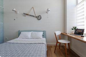 A bed or beds in a room at Scandi Apart Odessa