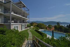 a building with a swimming pool next to a house at The View in Baveno