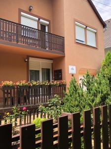 a house with a fence in front of it at Family 2-rooms Apartment in Hévíz