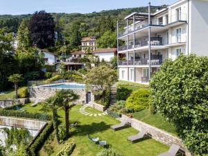 an apartment with a garden and a building at The View in Baveno