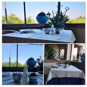 a table with a white table cloth and blue pot plants at Locanda Miranda in Tellaro
